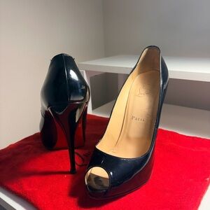 Christian Louboutin Very Prive black patent leather peep-toe pumps.